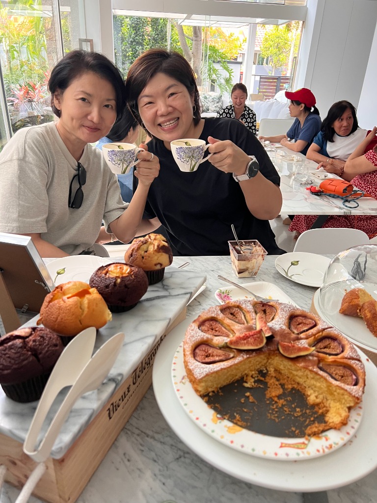 Friends enjoying tea cups and cakes